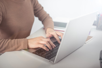Naklejka premium business woman working on white desk with laptop, pad, smartphone at office look very busy. work from home concept