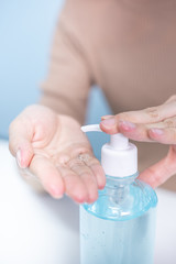 woman hands using alcohol gel for protect corona virus and bacteria, cleaning virus, healthy, covid-19, tree background, quarantine concept.