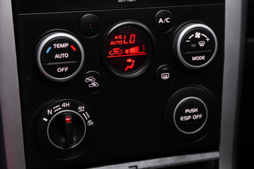 Modern black car interior: climat control view with air conditioning button, the dashboard with information about temperature inside a car.