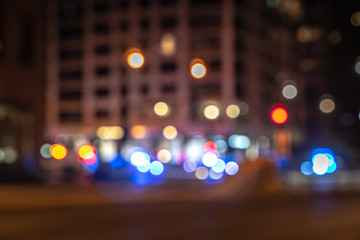 An out of focus cityscape background image of Michigan Avenue in downtown Chicago with red and blue...