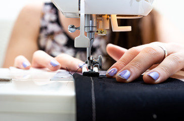 Woman creating a mask with a sewing machine