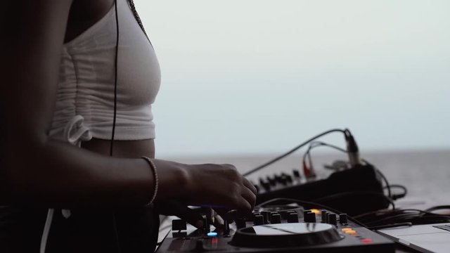 DJane working on mixing board