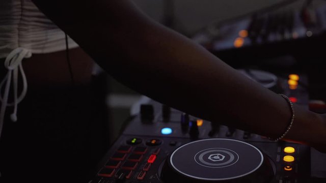 DJane working on mixing console