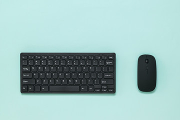 Wireless keyboard and mouse on a light blue background.