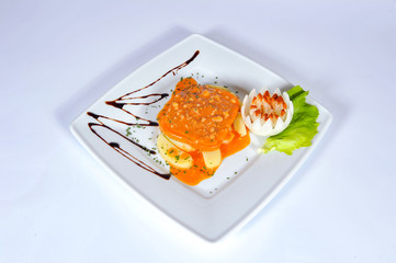 plate with meat, vegetables and sauces