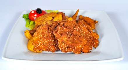 plate with french fries, crispy, fried meat, vegetables, juices and bread