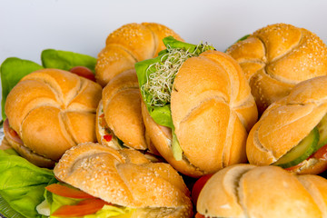 meat burger platter between bread with salad, tomato sauce, ketcup, french fries