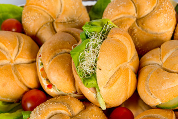 meat burger platter between bread with salad, tomato sauce, ketcup, french fries