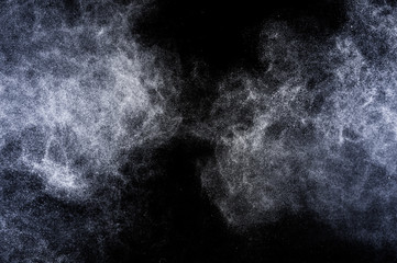 Explosion of blue powder on black background