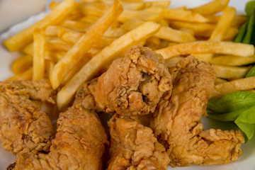 plate with french fries, crispy, fried meat, vegetables, juices and bread