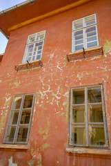 Fototapeta na wymiar the door and windows of an abandoned brick house
