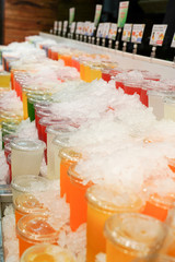 Display of Fruit juice in plastic glass with cold ice