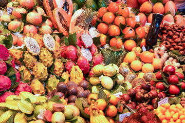 Multiple fruits display (Pomegranate,dragon fuits, Passion fruits,star apple, Papaya, Tomato,Mangosteen, Mango) in Barcelona market, Spain