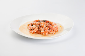 prawns in sauce on a white background