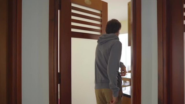 Man opens a door with his elbow. Proper actions during coronavirus pandemic. Illness prevention concept