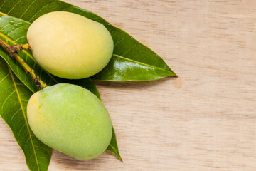 Wild mango on wooden background