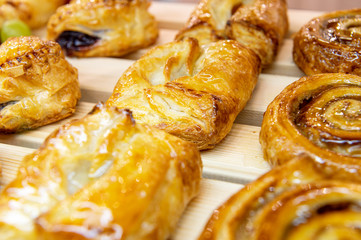 Tasty, beautiful sweet cakes with filling. The rolls are coated with sugar icing.