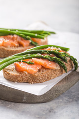Healthy vegetarian meal. Toast,  asparagus, salmon fish. Stone background. Clean eating Diet. Organic food.