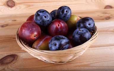 Different color plums on table