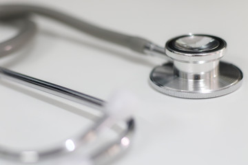 Stethoscope isolated equipment on white texture with blurred background