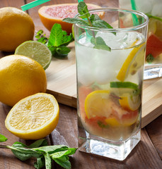 Summer refreshing drink with ice. Three types of citrus lime, lemon, pink grapefruit. Natural citrus lemonade with mint.