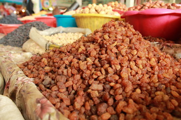 Raisins closeup in the traditional market with other food in the background
