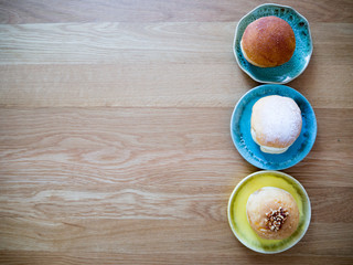Top view of sweet bakery in ceramic wares on wood background.Space for text.(Color boost up)