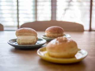 Close up doughnuts on ceramic plates. Concept for cafe vibe.(selective focus)