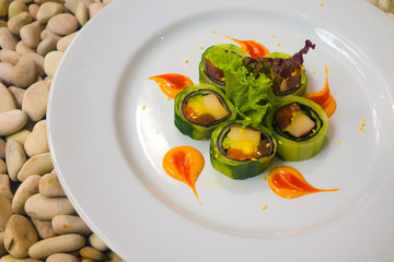 Japan gourmet cuisine - closeup detail on delicious and delicate dish of Japanese sushi rolls in slate on stone bg in traditional healthy Asian food and creative oriental dining