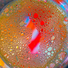 water and oil on a multicolored background