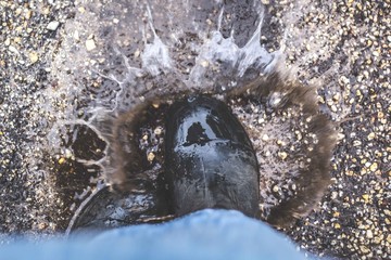 Gumboots splashing in a puddle of water