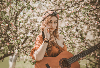 Gypsy woman with guitar at field, lifestyle, ideas for costume on Halloween