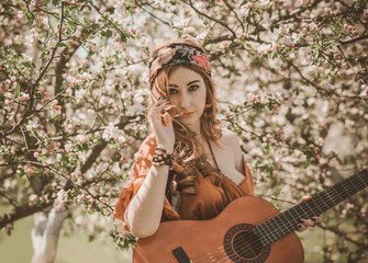 Fototapeta na wymiar Gypsy woman with guitar at field, lifestyle, ideas for costume on Halloween