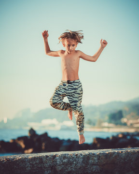 teen jumps on the background of the sea
