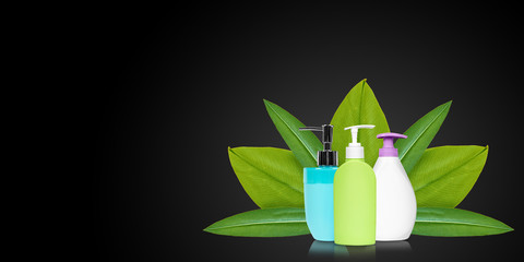 Different liquid soap bottles with leaves.