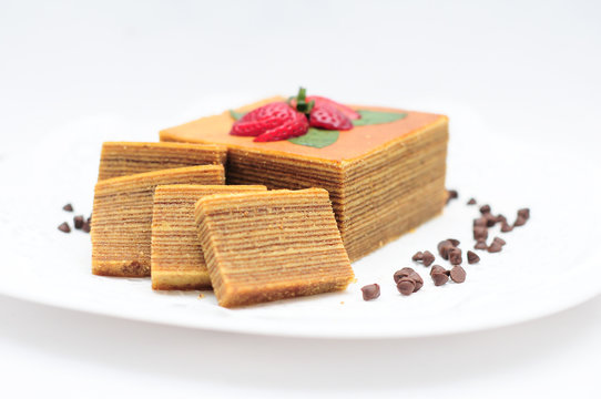 Traditional Malaysian Dessert Kek Lapis Sarawak or Sarawak layered cake on isolated white background. Malaysian kuih.