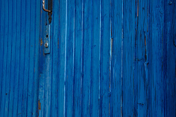 old blue wooden door. Details of old door panels painted in bright blue color
