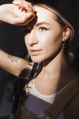 Portrait authentic blonde young woman posing with painting tools. Inspiring beauty concept. Art...