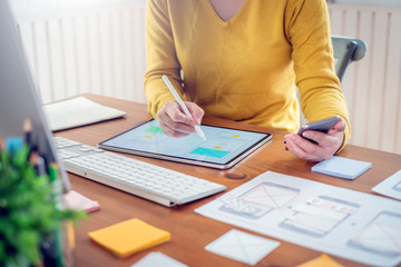 Young asian woman designer planning develop application develop for mobile phone at home.