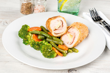 Meatloaf with vegetables on a white plate