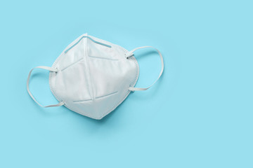 KN95 face mask on blue background protection against pm 2.5 polution and COVID-19 coronavirus....