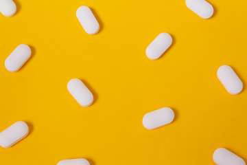 Vitamins for energy yellow background. Close up.