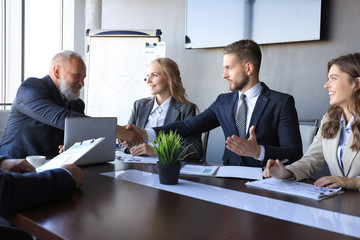 Business people shaking hands, finishing up a meeting.