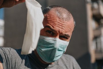 Man in the protective mask, outside on a sunny day