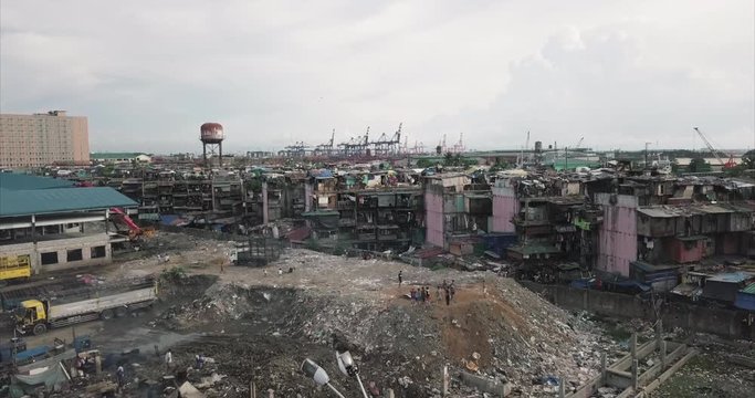 Aerial flight over garbage dump towards poor housing area, Tondo, Manila, Philippines