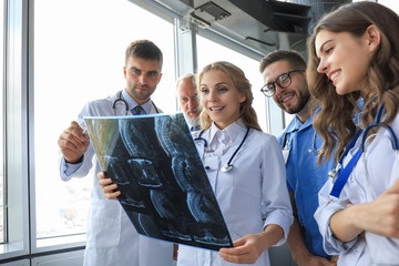 Group of doctors checking x-rays in a hospital.