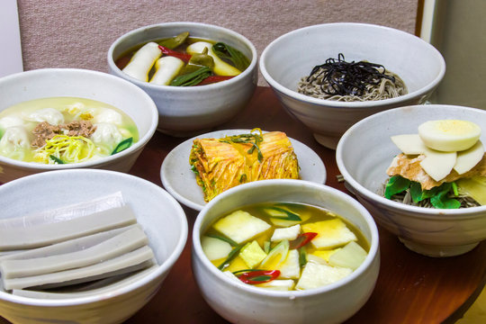 Table for special seasonal Korean feed in winter, which includes kimchi, "Tteokguk" (soup with sliced rice cakes), noodle and so on. All these in the photo are model 
