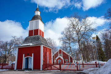 Jukkasjarvi Church, a Wooden red-colored church with a stand-alone bell tower in Swedish Lapland...