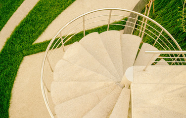 Top view of spiral stairway in rooftop ornamental garden in urban setting