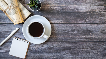 Coffee and notebooks placed on wooden tables 